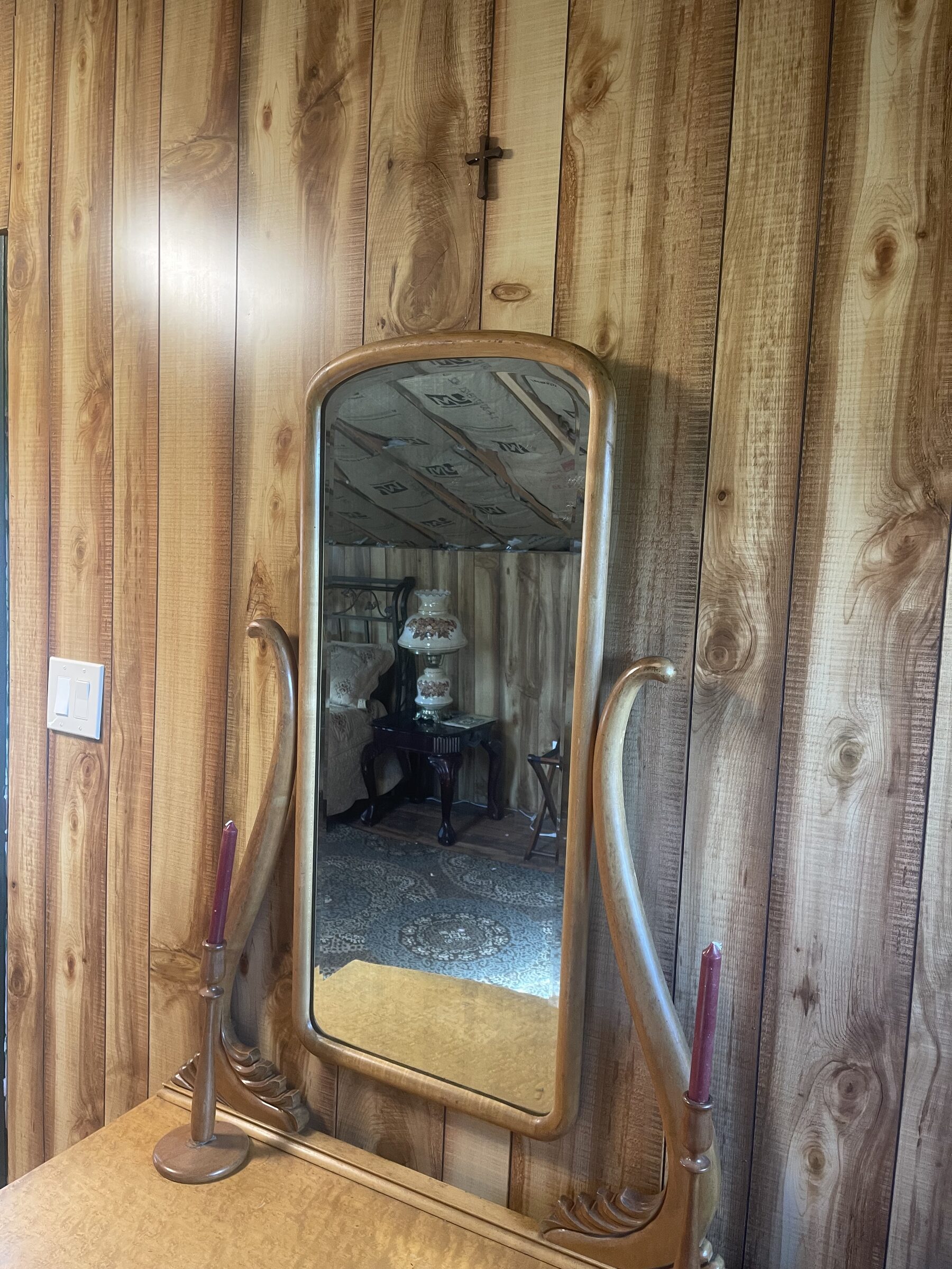 An ornate antique art-nouveau mirror reflecting the lamplight inside Whiskey Ridge at Sweetwater Ranch