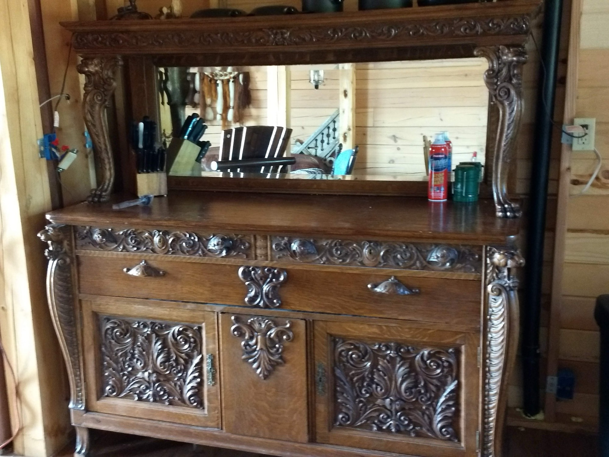 An ornately carved century-old antique sideboard with mirror inside the cabin at Sweetwater Ranch