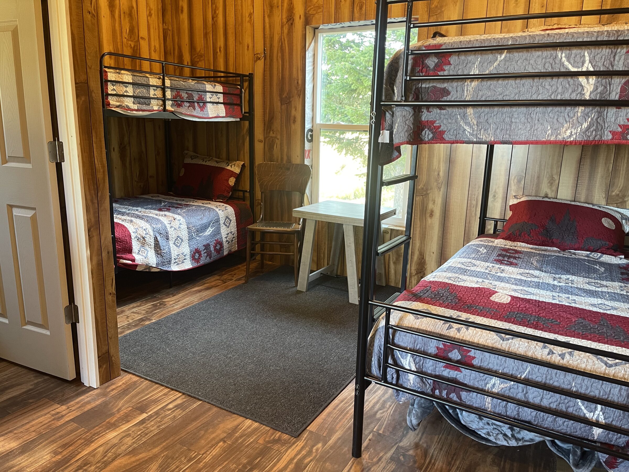 Knotty-pine bunk beds inside the Whiskey Ridge bunkhouse at Sweetwater Ranch