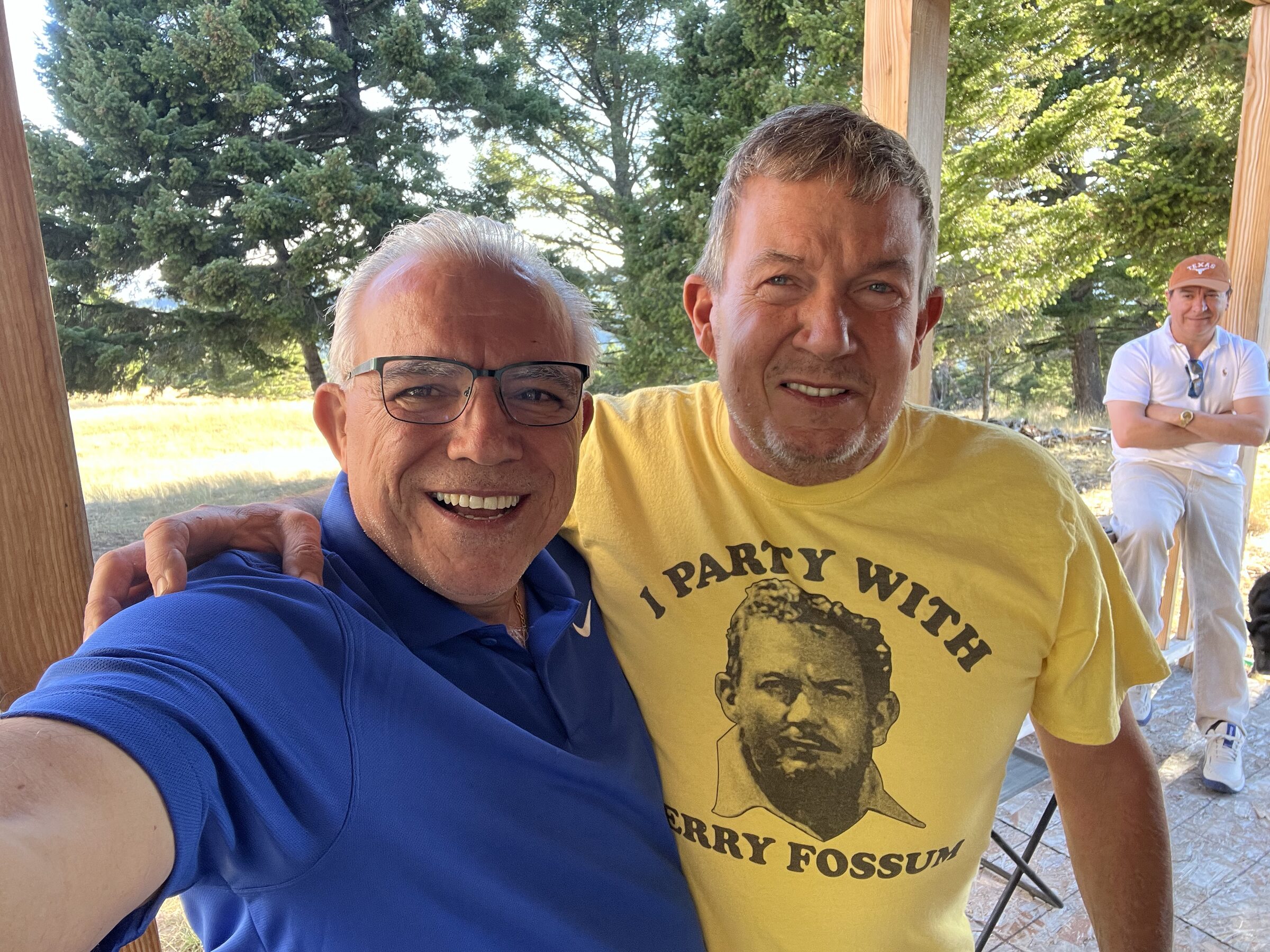 A friend wearing an 'I Party With Terry Fossum' shirt beside Terry L. Fossum at Sweetwater Ranch